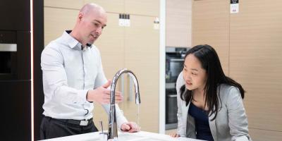 2 people looking at a tap